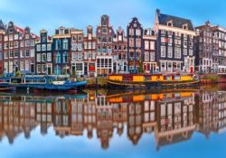 Amsterdam canal Singel with dutch houses Panorama of Amsterdam canal Singel with typical dutch houses and houseboats during morning blue hour, Holland, Netherlands.