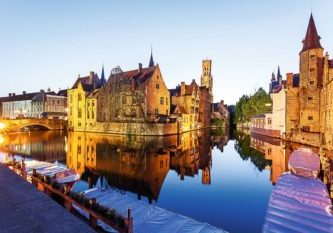 Brugges In Brugges at sunset during the blue hour, you see the refection of the building and the tower