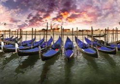 <> Gondolas at St. Mark's Square with the island Isola di San Giorgio Maggiore and a cloudy sky in the evening light, Venice, Veneto, Italy, Europe